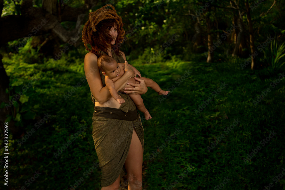 Portrait of a mother with Newborn Baby in forest. Wilde life Portrait of a mother with Newborn Baby in forest. Wilde life