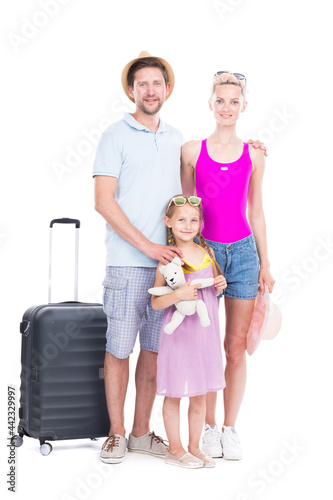 Vertical full length studio portrait of family with one child wearing summer outfits ready to travel on vacation, white background