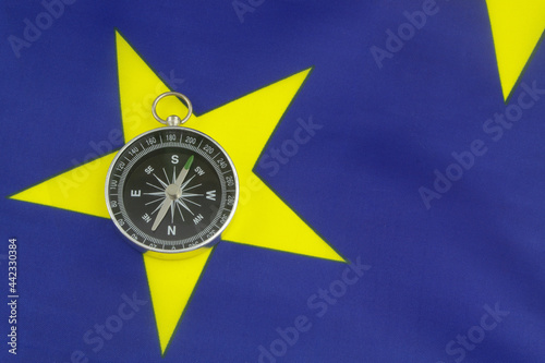 Travel, navigation and ways for developing for European Union concept. Compass on EU flag. photo