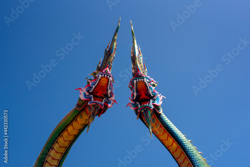 Udon Thani, Thailand - 21 June 2021 : Twin Stucco painted as a large serpent at Pra kai keaw wang nakin, Located at Ban Don swan, Phen District, Udon Thani, Thailand. photo