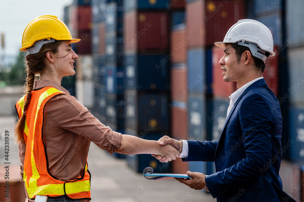 Container Depot chief shaking hands and talking to female foreman about ...