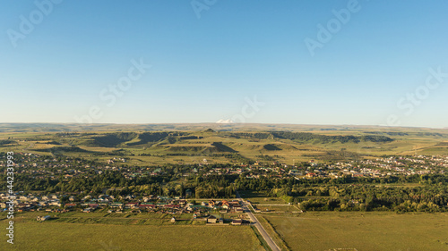 Beautiful landscape of the city in the foothills on an early sunny summer morning.