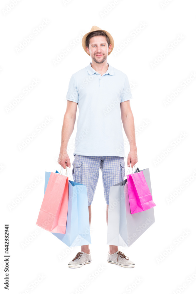 Vertical full length studio portrait of handsome man wearing summer outfit carrying shopping bags, white background Vertical full length studio portrait of handsome man wearing summer outfit carrying shopping bags, white background