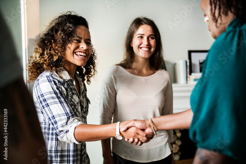 Diverse woman shaking hands