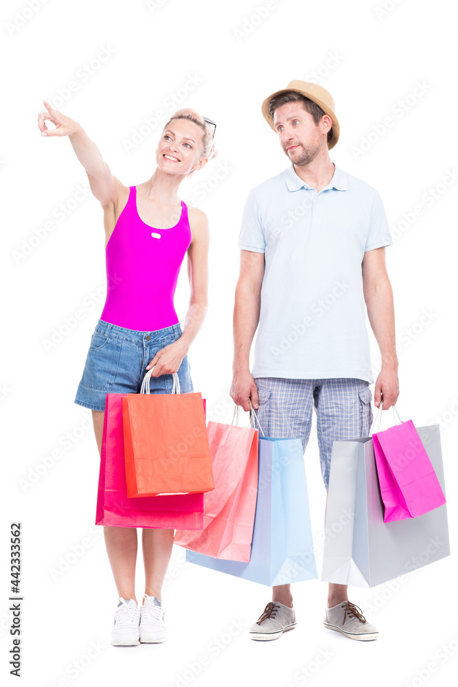 Vertical full length studio portrait of handsome man and beautiful woman wearing summer outfits carrying shopping bags, white background Vertical full length studio portrait of handsome man and beautiful woman wearing summer outfits carrying shopping bags, white background