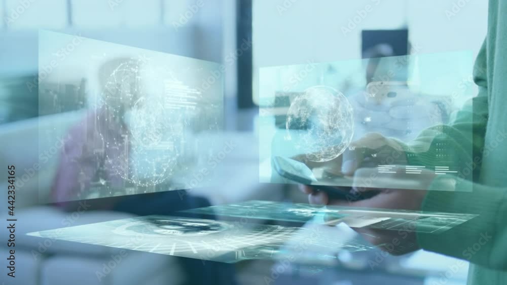 Screens with data processing against mid section of businessman using smartphone at office Screens with data processing against mid section of businessman using smartphone at office