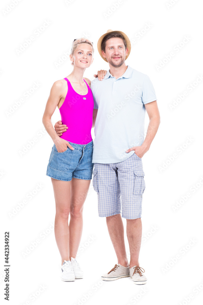 Vertical full length studio portrait of stylish young man and woman wearing summer outfits standing together embracing each other, white background Vertical full length studio portrait of stylish young man and woman wearing summer outfits standing together embracing each other, white background