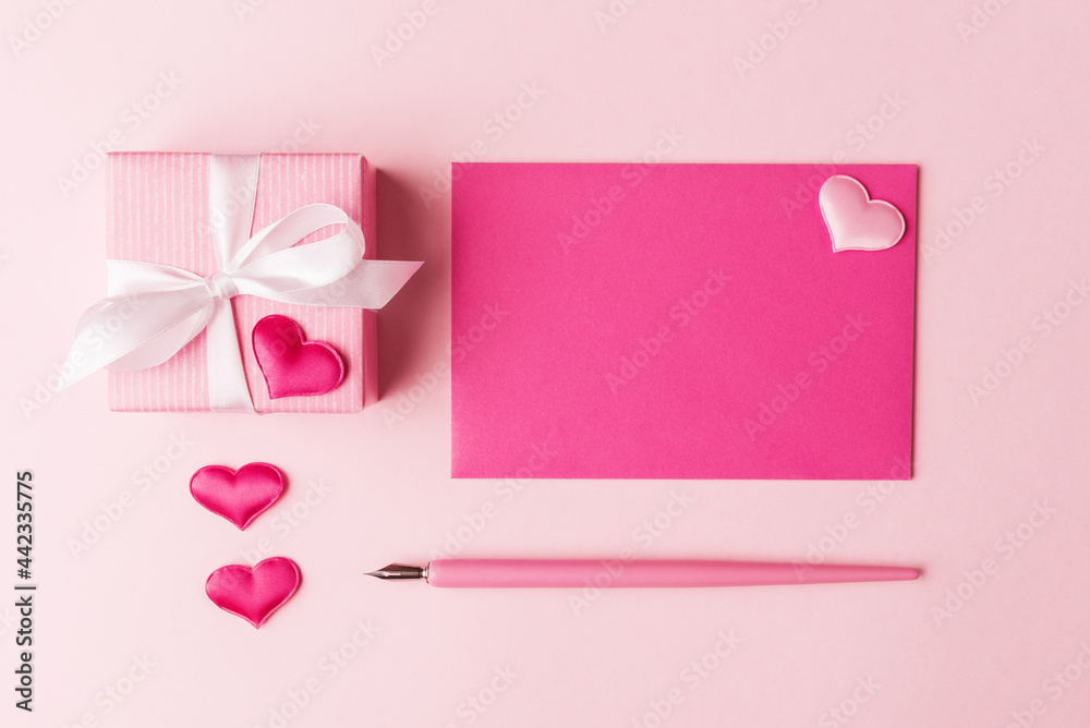 Blank card, gift box and Valentine’s hearts over pink background. Valentines greeting concept