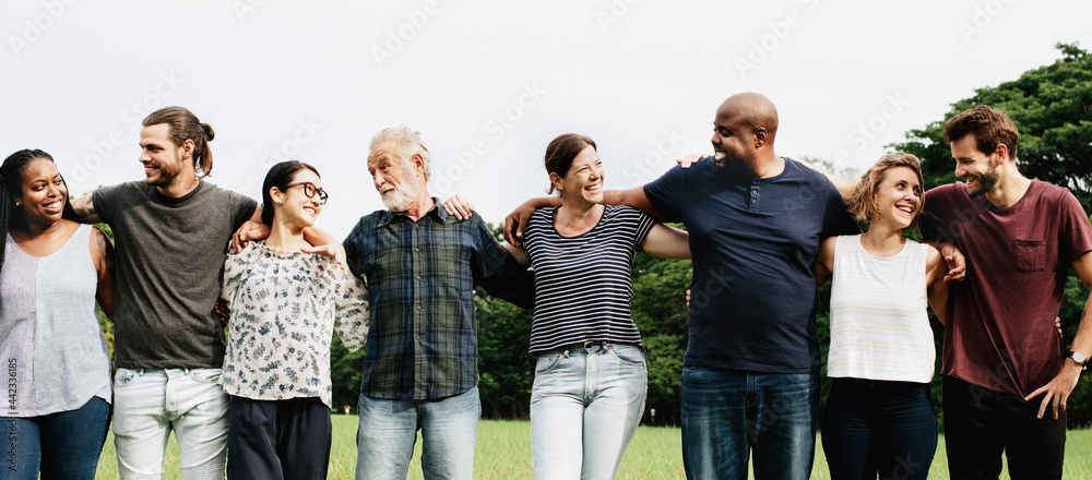 Obraz premium Group of people hugging each other in the park