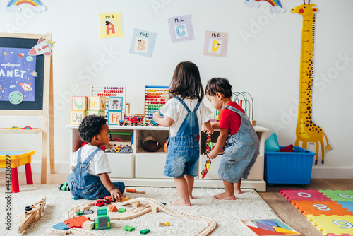 Young children enjoying in the playroom photo
