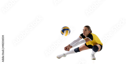 Female professional volleyball player with ball isolated on white studio background. The athlete, exercise, action, sport, healthy lifestyle, training, fitness concept. photo