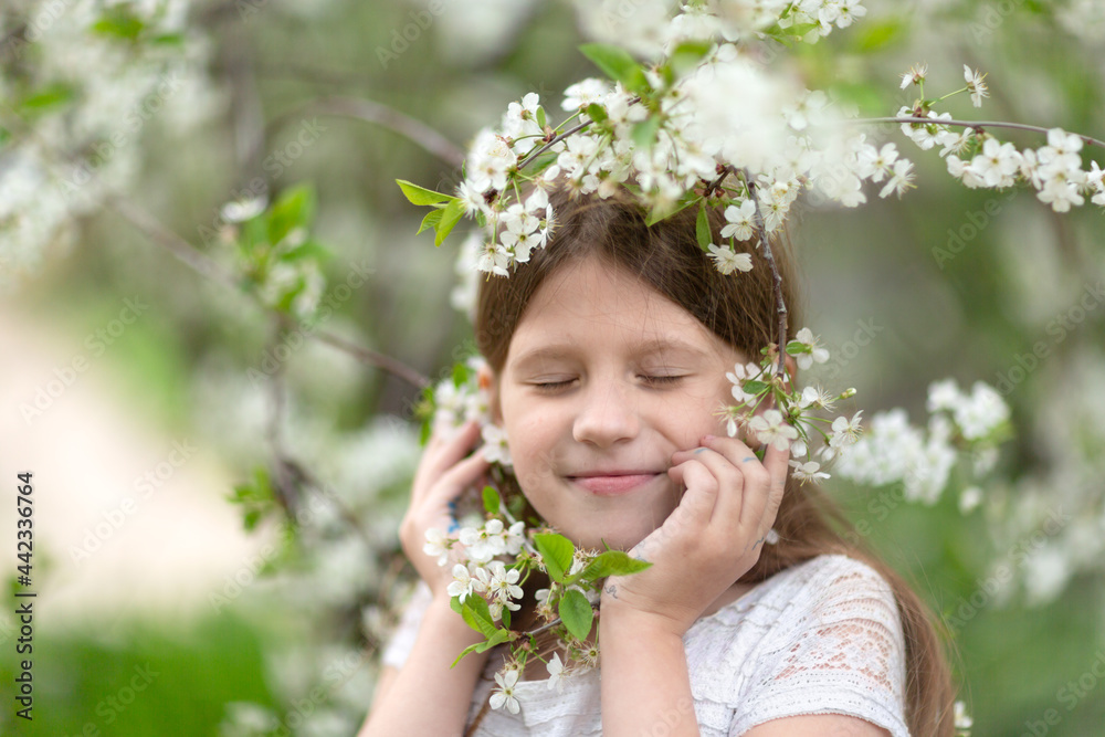 Adorable European kid girl with cherry blossom flowers, spring and self-care, tender child girl photo, childhood