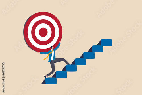 Fotografija Effort and ambition to reach goal or target, challenge to win higher target, business mission or career concept, strong businessman carry big target on his shoulder walking up the stairs