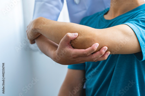 Physician consulting patients about elbow muscle pain problem ,office syndrome problems, physiotherapy diagnosis concept
