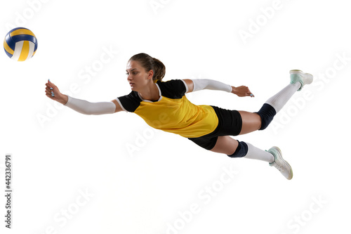 Female professional volleyball player with ball isolated on white studio background. The athlete, exercise, action, sport, healthy lifestyle, training, fitness concept.