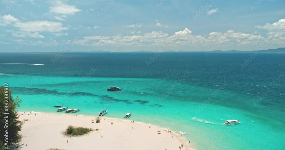 White sand beach and coral reef aerial. Turquoise transparent ocean water and luxury yacht boats on the shore. Beautiful wild landscape. Exotic summer travel vacation. Drone flight slow motion rise up White sand beach and coral reef aerial. Turquoise transparent ocean water and luxury yacht boats on the shore. Beautiful wild landscape. Exotic summer travel vacation. Drone flight slow motion rise up