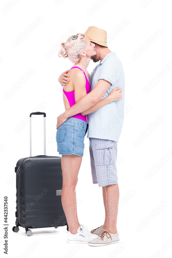 Vertical full length studio portrait of young man and woman in love wearing summer outfits embracing each other, white background Vertical full length studio portrait of young man and woman in love wearing summer outfits embracing each other, white background