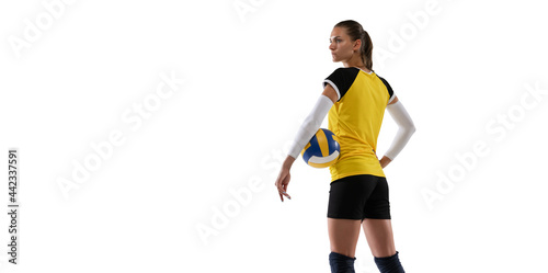 Young female volleyball player isolated on white studio background. Woman in sport's equipment and shoes or sneakers training and practicing.