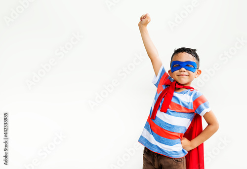 Little boy playing superhero at the playground photo
