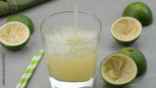 Serving freshly prepared sweet lime juice in a glass cup photo