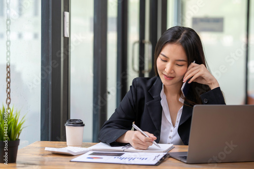 Accountant woman happy working in new office, business woman talking on the phone to agree a business deal.