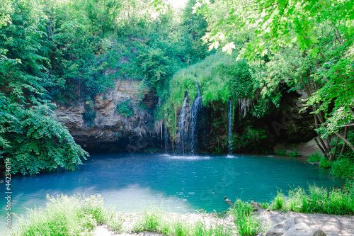 small beautiful waterfall with blue lake