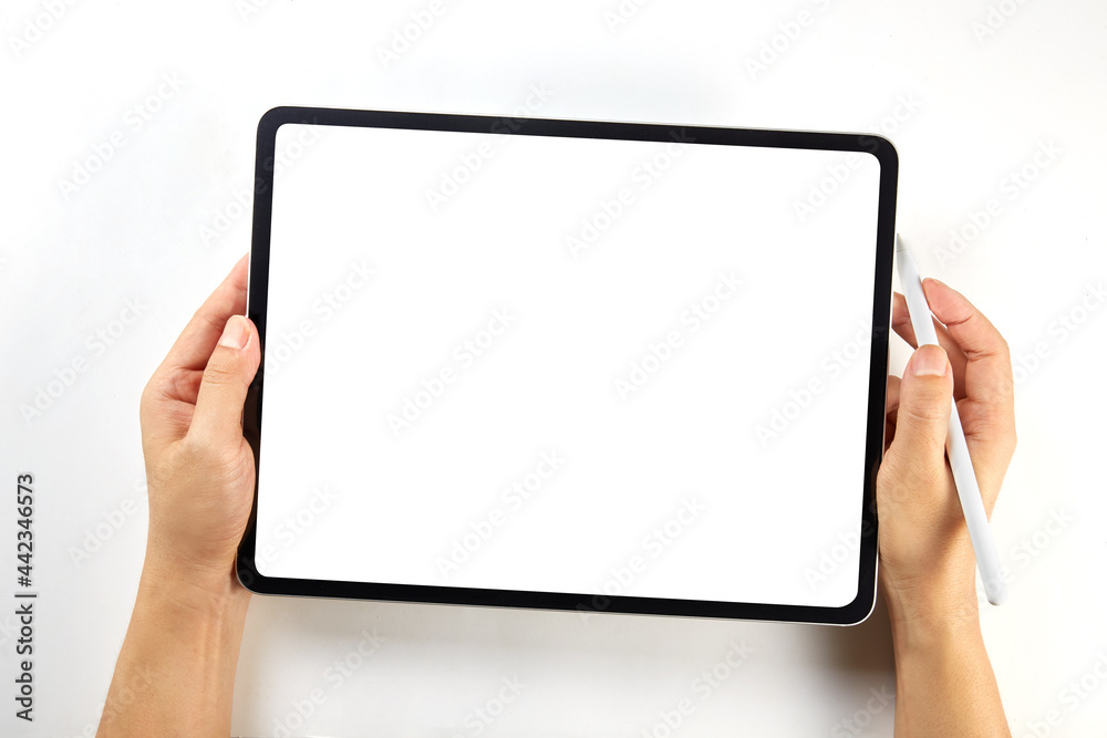 Hand holding a mockup tablet and pencil with blank screen isolated on white
