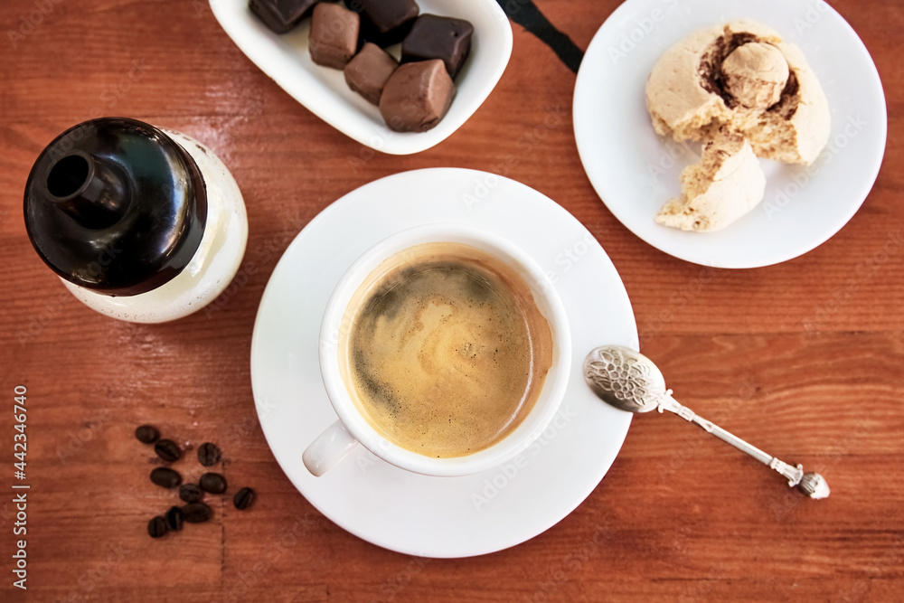 Cup of americano on wooden table with cookie and chocolate. Cup of americano on wooden table with cookie and chocolate.