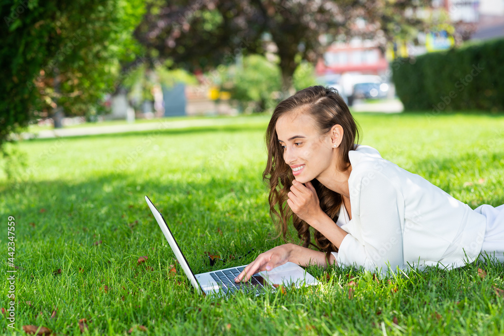 young woman and laptop in the park young woman and laptop in the park