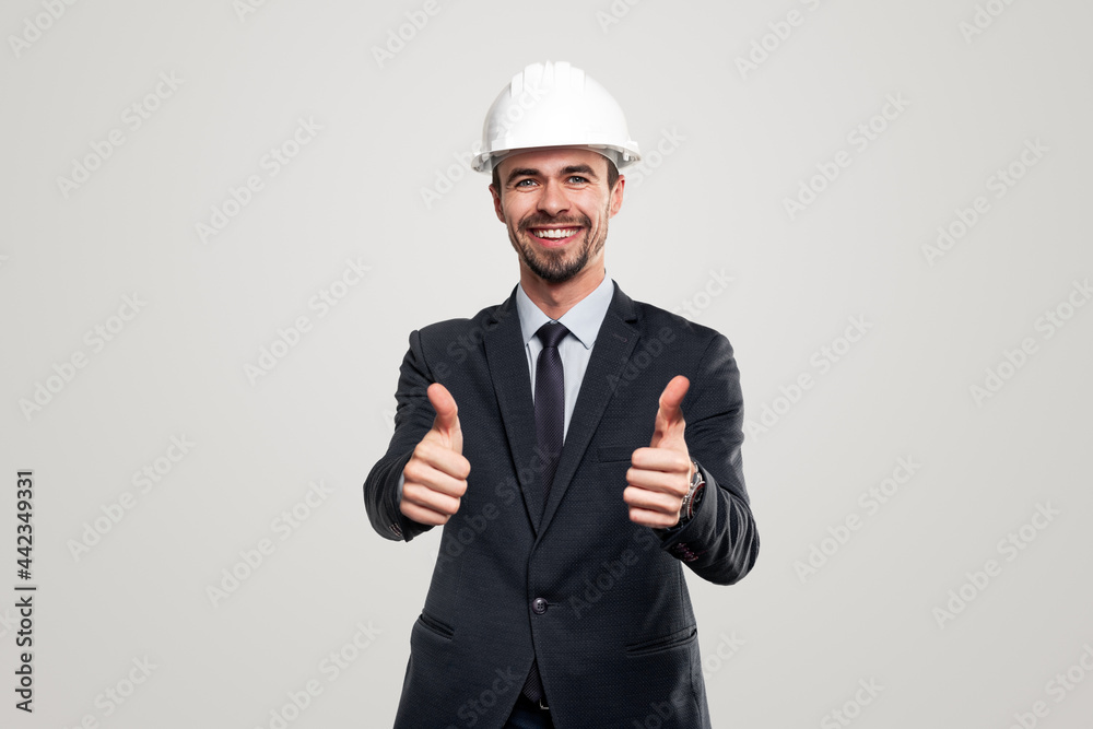 Happy businessman in hardhat showing thumbs up Happy businessman in hardhat showing thumbs up