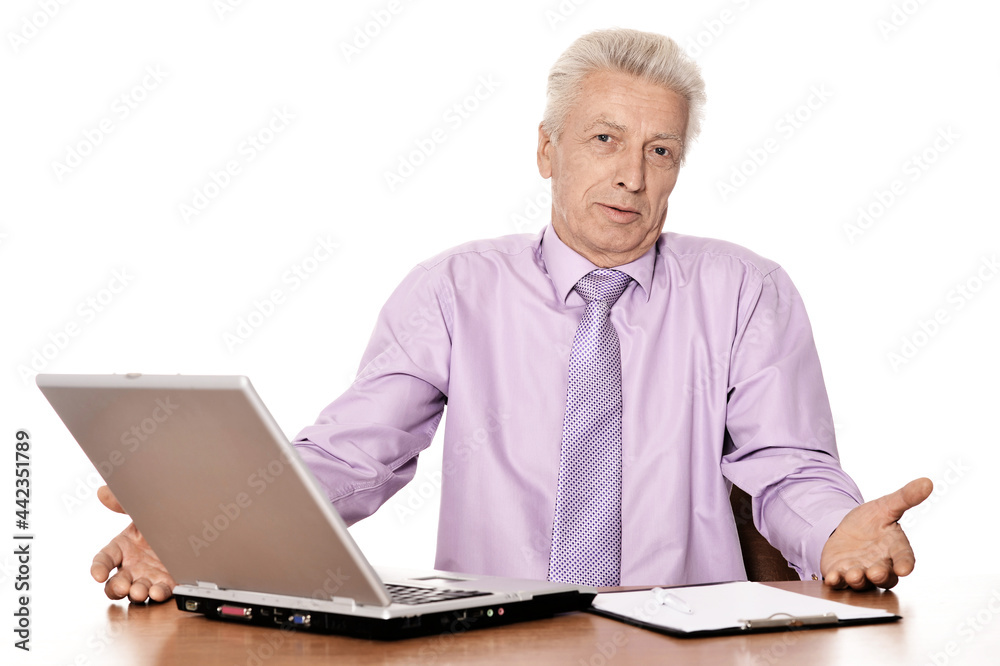 Old businessman working with laptop isolated on white background Old businessman working with laptop isolated on white background