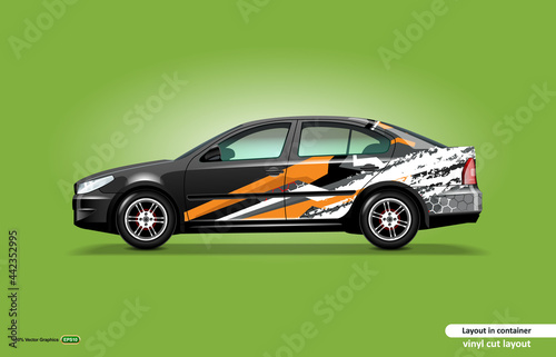 Car decal wrap design with abstract orange stripe theme on black sedan car.