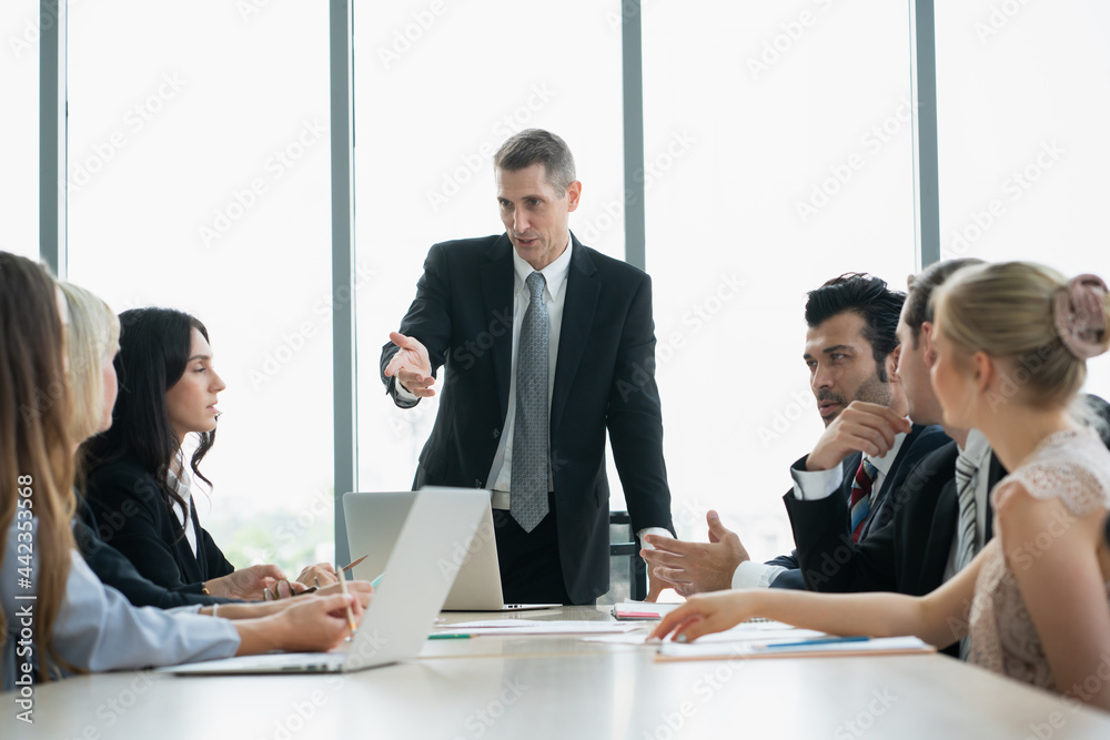 group of business people working and disussing a project together at meeting room group of business people working and disussing a project together at meeting room
