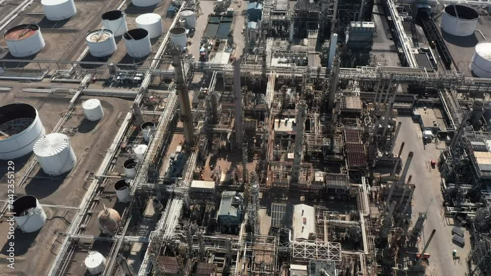 Aerial panorama of refinery plant, production line with oil storage tanks and steel pipes