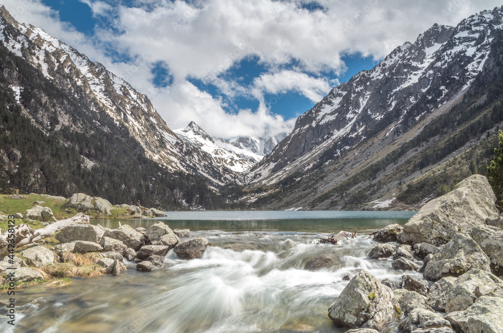 View of Lac de Gaube with running water and rocks, Cauterets, Pond d'Espagne, France