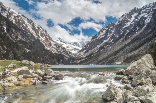 View of Lac de Gaube with running water and rocks, Cauterets, Pond d'Espagne, France