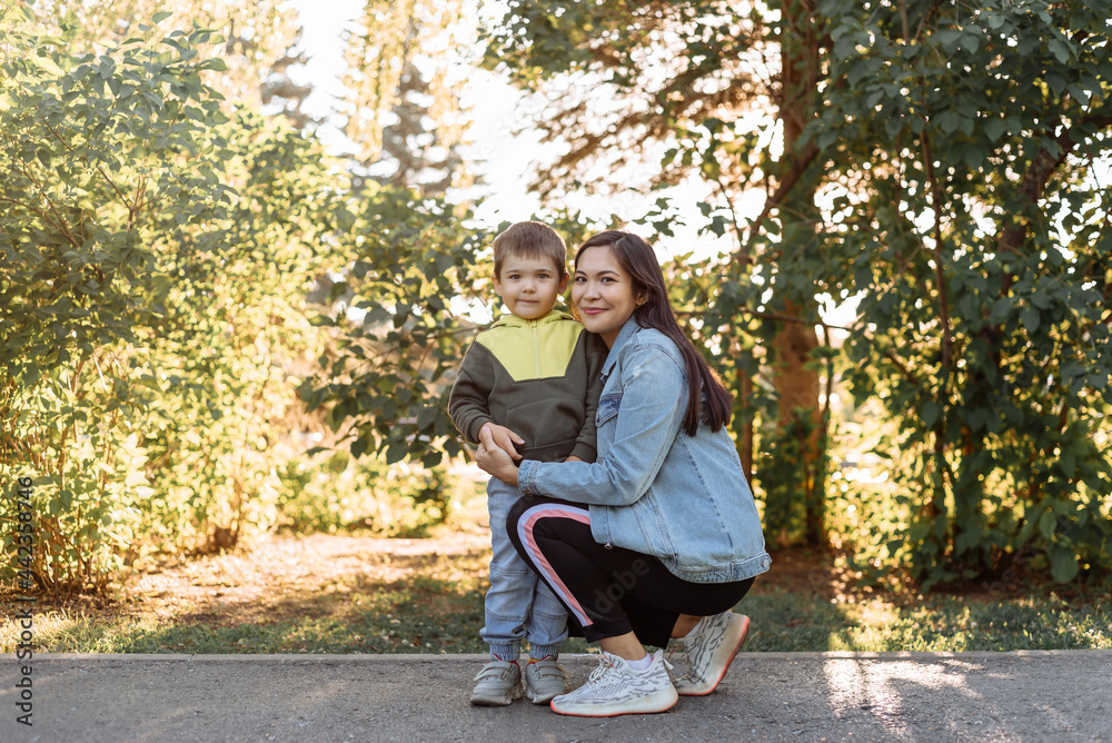 portrait of a happy young mother with a young son in the park. the concept of happy motherhood portrait of a happy young mother with a young son in the park. the concept of happy motherhood