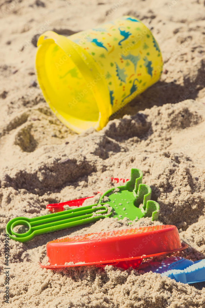 Different shapes made of sand and children toys for playing on beach. Vacation time and child development Different shapes made of sand and children toys for playing on beach. Vacation time and child development