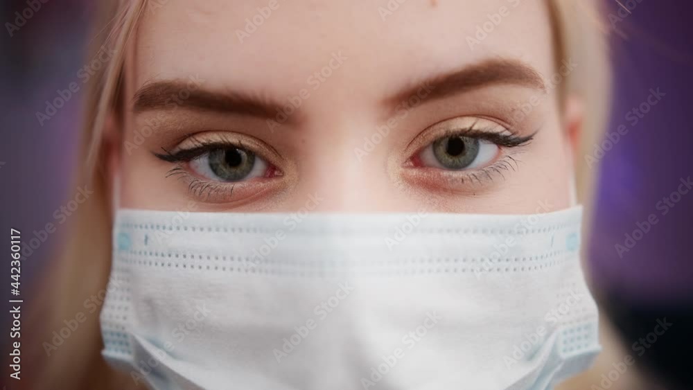 Happy cheerful young woman teenager portrait in medical safety protection mask coronavirus covid 19 lockdown. Student relaxing indoors after college or university, generation z millennial. Happy cheerful young woman teenager portrait in medical safety protection mask coronavirus covid 19 lockdown. Student relaxing indoors after college or university, generation z millennial.