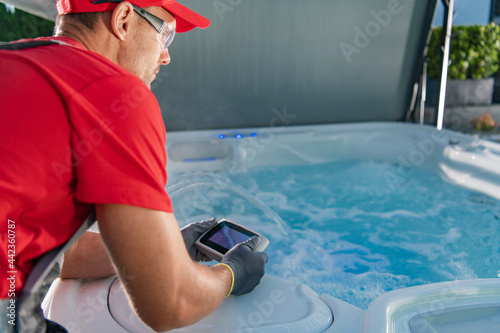 Fotobehang Garden SPA Technician Testing Hot Tub Remote