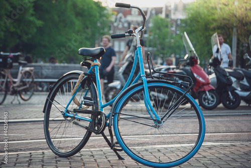 Blue vintage bicycle in a Netherlands city with a road