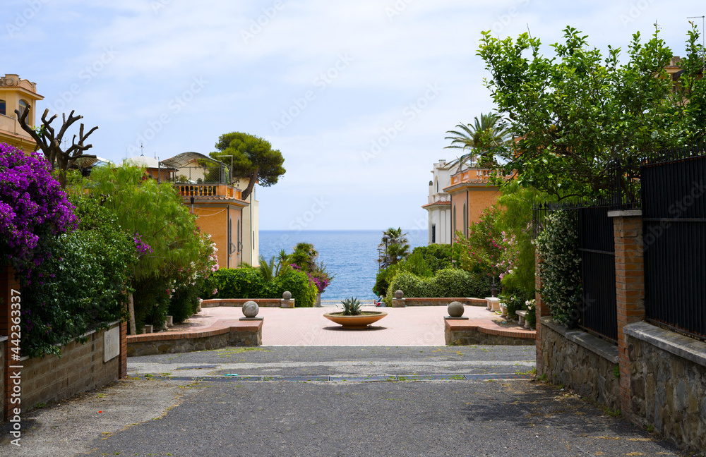 Santa Marinella, Italy -  June 16 2021: Street on the way to the beach in Italian village