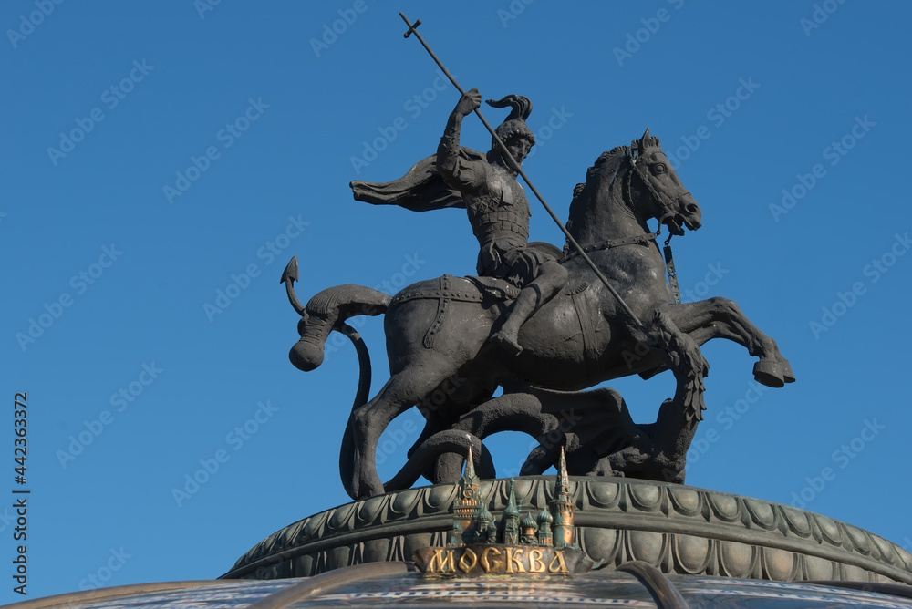 Obraz premium Saint George strikes the Serpent with a spear. St. George the Victorious is a symbol of the city of Moscow. On the spherical dome of the Okhotny Ryad Shopping Center n the Manezhnaya Square