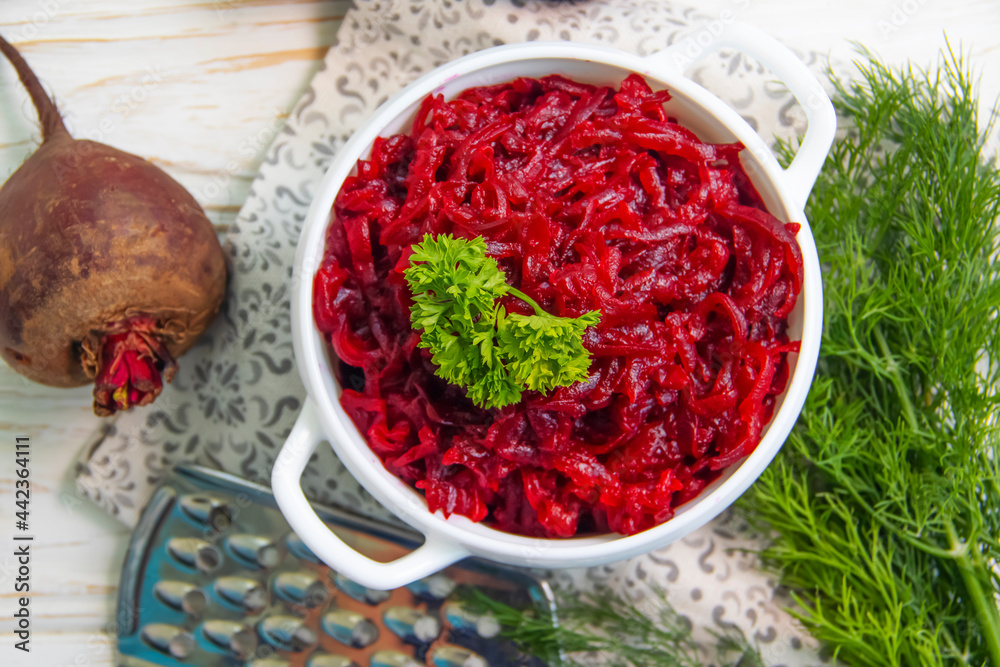 boiled grated beetroot on a wooden background boiled grated beetroot on a wooden background