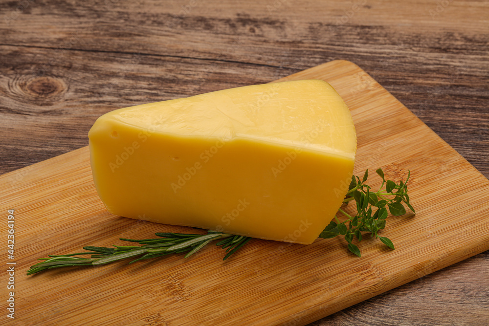 Hard cheese piece served rosemary