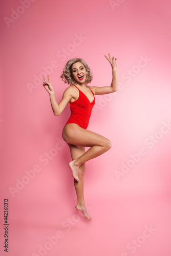 Full length of a happy young blonde woman in swimsuit