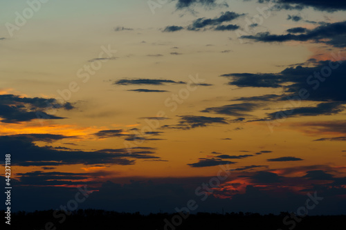 beautiful sunset sky  bright sunlight and silhouette of clouds as a background