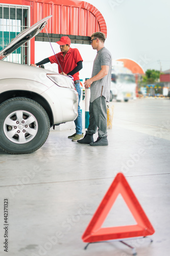 Wallpaper Mural caucasian car owner and Asian gas station worker man checking auto car engine behind traffic sign after fill energy power fuel in car tank, commercial service for benzine, diesel, gasohol, gasoline Torontodigital.ca
