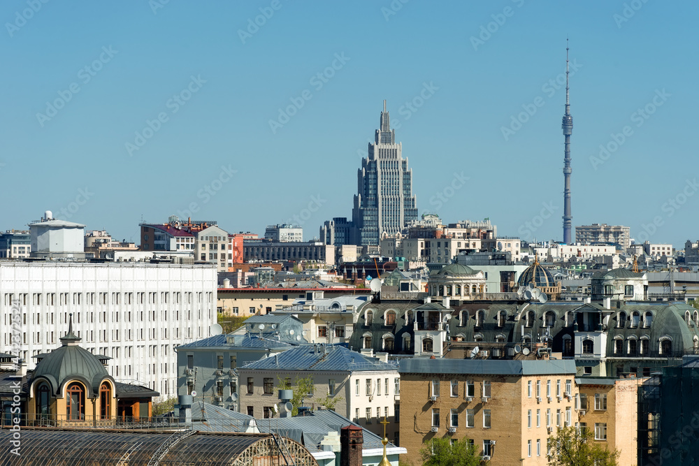 Top view of the rooftops of residential buildings in the Arbat district, Moscow. Business center Oruzheiny and Ostankino TV tower in the background