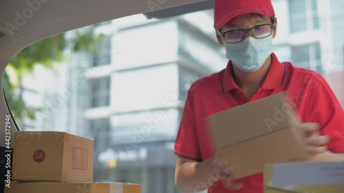 Business concept of 4k Resolution. A delivery worker carrying parcels in the city.